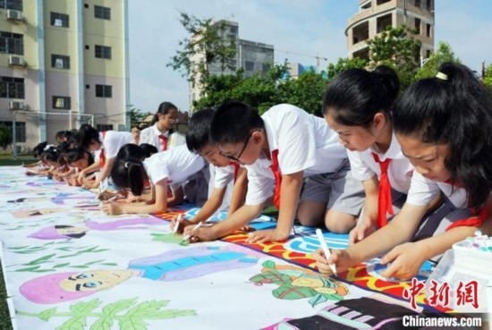 圖為學生們用手中畫筆在進行創(chuàng)作。 興業(yè)縣融媒體中心供圖