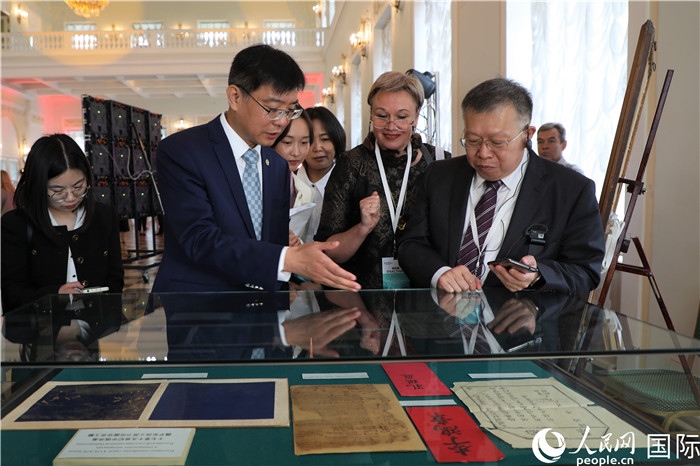 中俄圖書館論壇嘉賓共同參觀由俄羅斯國立列寧圖書館舉辦的館藏中國古籍善本圖書展。人民網(wǎng)記者 隋鑫攝）