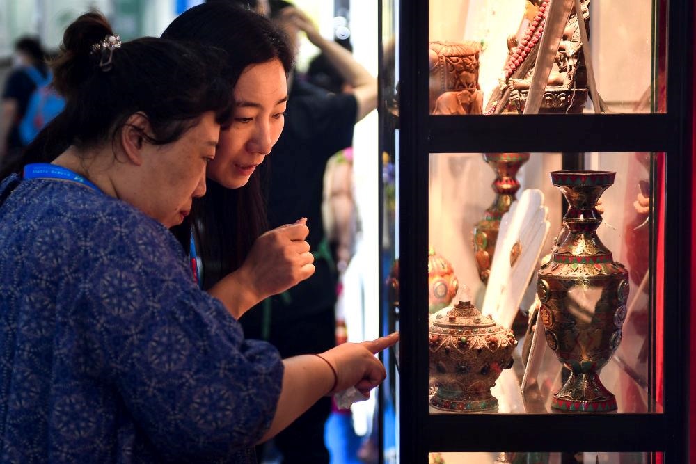 △2023年8月24日，參觀者在第十四屆中國—東北亞博覽會現(xiàn)場選購尼泊爾特色商品。