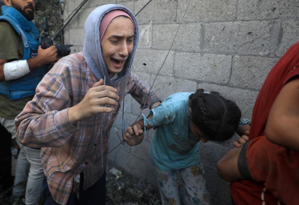 11月6日，人們從加沙地帶中部地區(qū)一處被炸難民營逃離。新華社發(fā)（亞西爾·庫迪攝）