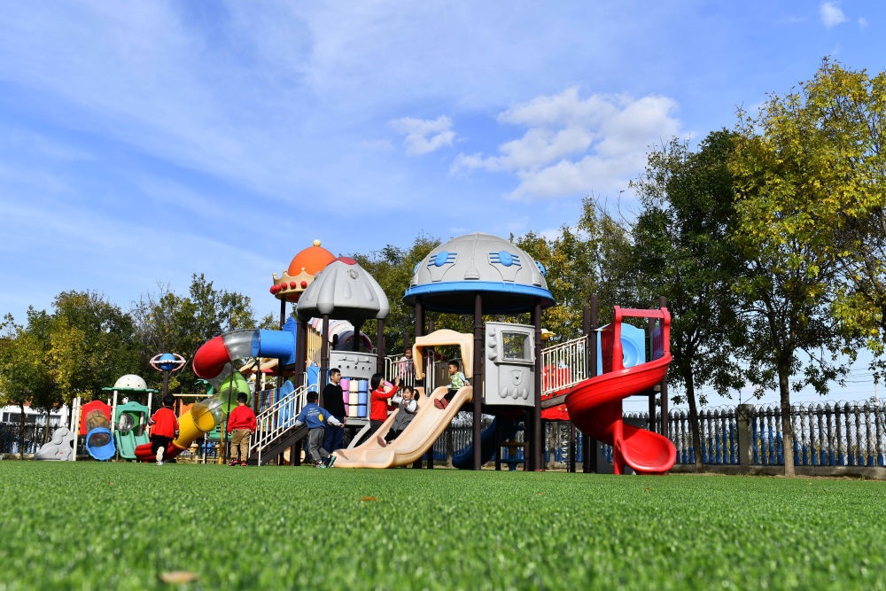 在山東省東營市墾利區(qū)楊廟社區(qū)幼兒園，孩子們在老師的帶領(lǐng)下進(jìn)行戶外活動（2021年10月19日攝）。新華社記者 郭緒雷 攝