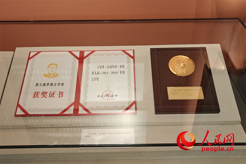 《這邊風景》獲得的第九屆茅盾文學獎證書與獎牌。人民網(wǎng)記者 韋衍行攝