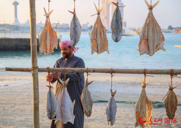  手工藝者展示如何晾曬魚干。人民網(wǎng) 塔里克·易卜拉欣攝