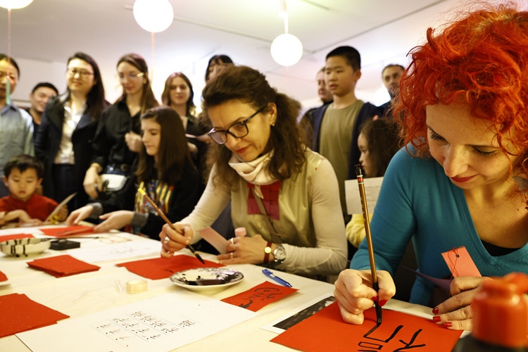 羅馬尼亞觀眾學(xué)習(xí)用毛筆寫(xiě)“福”字。中國(guó)文化中心供圖