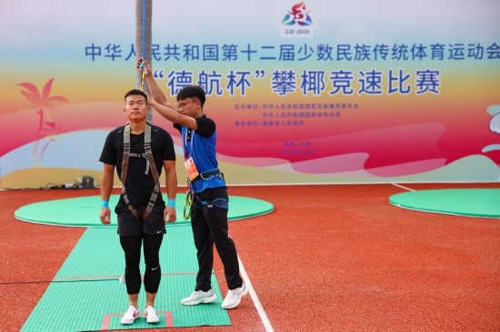 11月23日，工作人員為上海隊(duì)選手付樂(lè)樂(lè)（左）系安全繩。新華社記者 楊植森 攝