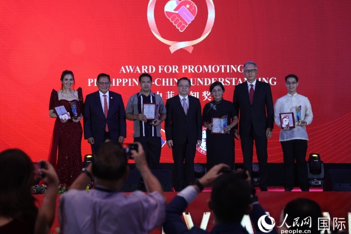 黃溪連大使和菲中了解協(xié)會(huì)主席與榮獲“友誼獎(jiǎng)”的獲獎(jiǎng)?wù)吆嫌傲裟?。人民網(wǎng)記者 樊帆攝